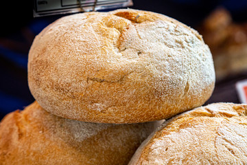 Freshly baked bread for sale on a market stall, with a shallow depth of field