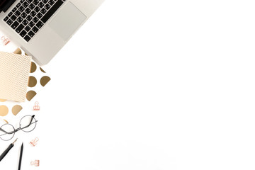 Border frame made of laptop, notepads, stationery, glasses on white desk