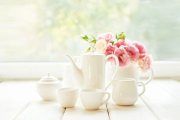 Spring card template. Happy Birthday or Valentine. Women's Day. Greeting card for mother's day. Congratulation with flowers. Flower card. Copy space. Wedding invitation.Tea set with flowers and sweet