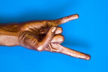 Human hands painted in gold color