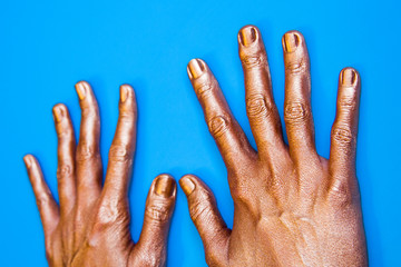 Human hands painted in gold color