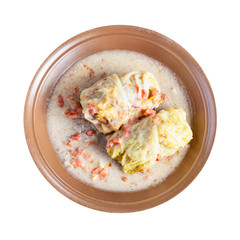 top view of stewed cabbage rolls on plate isolated