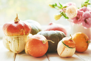 Thanksgiving Day table. Happy Halloween. Pumpkins, apples and flowers. Bright autumn background. Colorful autumn card. Autumn flower arrangement. Autumn bouquet.