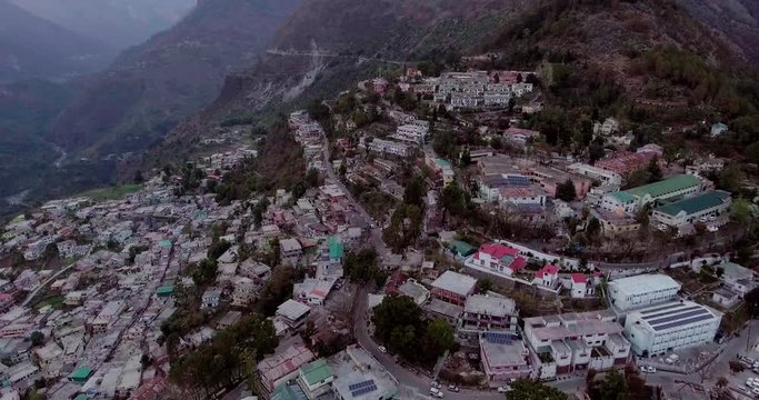 An aerial shot of a beautiful city situated in upper Himalayas- Chamoli, Uttarakhand, India. Uttarakhand hills and mountains.Himalayas peaks at the background.