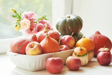 Thanksgiving Day table. Happy Halloween. Pumpkins, apples and flowers. Bright autumn background. Colorful autumn card. Autumn flower arrangement. Autumn bouquet.