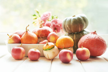 Thanksgiving Day table. Happy Halloween. Pumpkins, apples and flowers. Bright autumn background. Colorful autumn card. Autumn flower arrangement. Autumn bouquet.