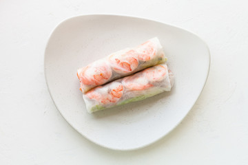 Vietnamese nem roll with shrimps on plate on board