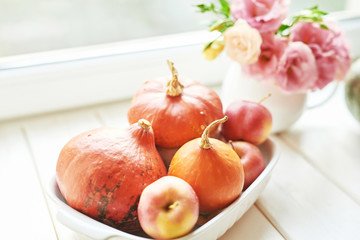 Thanksgiving Day table. Happy Halloween. Pumpkins, apples and flowers. Bright autumn background. Colorful autumn card. Autumn flower arrangement. Autumn bouquet.