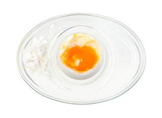 top view of open boiled white egg in glass egg cup