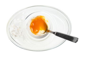 top view of soft egg with spoon in glass egg cup