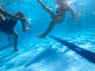 Underwater view from a girl with a red bikini in a pool