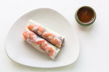 top view of Nem cuon rolls on plate on white board