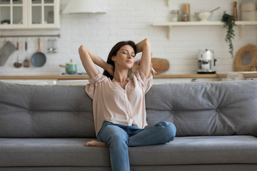 Woman enjoy free time resting on couch at home