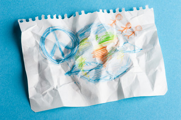 Crumpled sheet of paper with child drawing