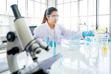 Asian scientist in the laboratory working at lab with test tubes concept