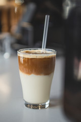 Iced Coffee in a glass, vertical shot, dark background