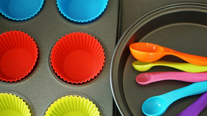 Silicone kitchen tools on a black background. Top view.    