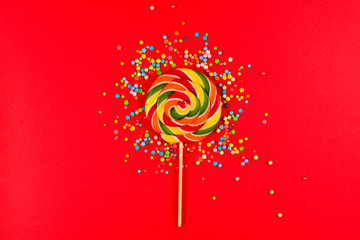 Colorful candy on a red  background. Lollipop. Top view. Copy space.