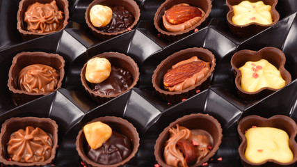 Chocolate candy collection in plastic box.