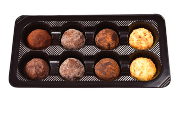 Chocolate candy collection in plastic box.