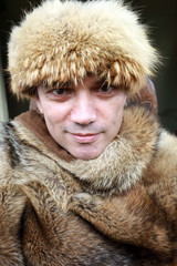 Man in fur cape and hat