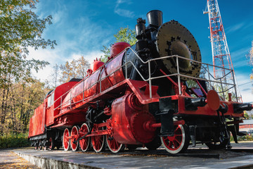 vintage red steam locomotive for rail cars