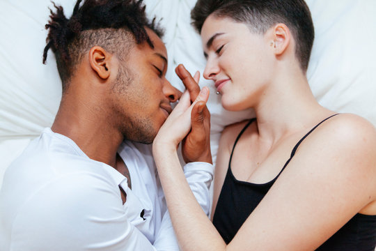 Mixed race couple having an intimate moment on the bedroom