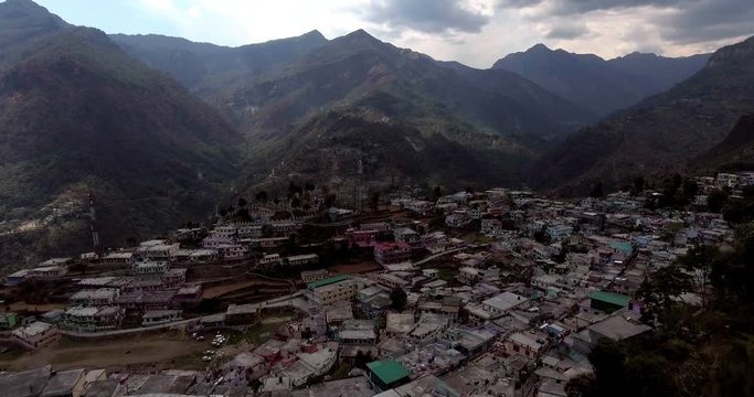 An aerial shot of a beautiful city situated in upper Himalayas- Chamoli, Uttarakhand, India. Uttarakhand hills and mountains.Himalayas peaks at the background.