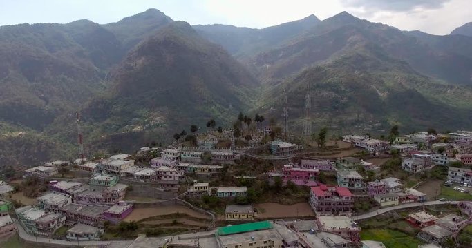 An aerial shot of a beautiful city situated in upper Himalayas- Chamoli, Uttarakhand, India. Uttarakhand hills and mountains.Himalayas peaks at the background.