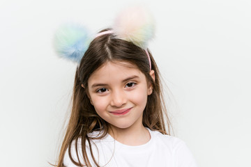 Little caucasian girl with costume and accessories having fun