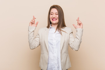 Young business woman crossing fingers for having luck