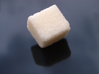 one sugar cube ofer black background