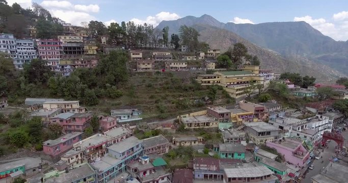 An aerial shot of a beautiful city situated in upper Himalayas- Chamoli, Uttarakhand, India. Uttarakhand hills and mountains.Himalayas peaks at the background.