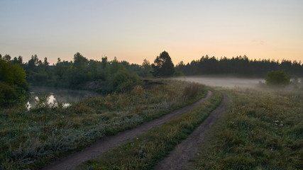Fototapeta premium A quiet dawn over the lake in a Sunny hazy light. Autumn time.