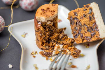 closeup view christmas mini cake crushed with fork on star shape plate with decorations