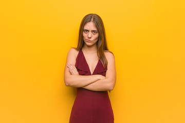 Obraz premium Young elegant woman wearing a dress crossing arms relaxed