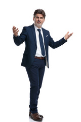 Positive businessman greeting with his arms wide open