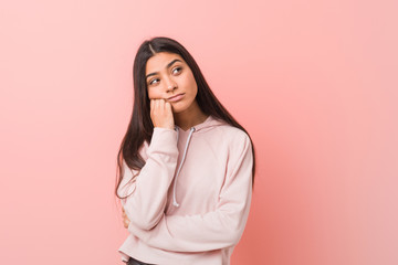 Young pretty arab woman wearing a casual sport look who feels sad and pensive, looking at copy...