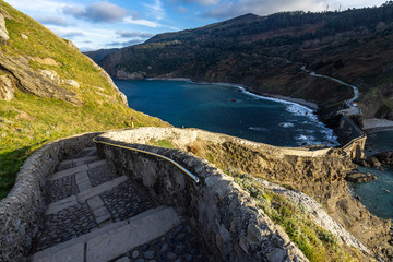 Stone stair descending the dramatic pathway from San Juan de Gaztelugatxe at sunset, Bermeo, Basque...