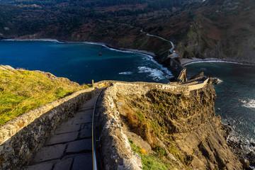 Stone stair descending the dramatic pathway from San Juan de Gaztelugatxe at sunset, Bermeo, Basque...
