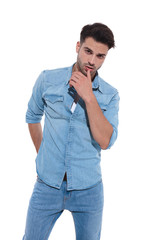 seductive young man wearing denim on white background