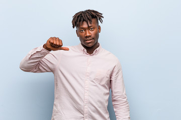 Young business african black man showing a dislike gesture, thumbs down. Disagreement concept.