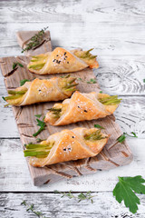 Green asparagus and cheese puff pastry folded as envelope and topped with sesame seeds