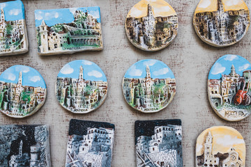 Many colorful magnets on the fridge of the urban landscape of Matera