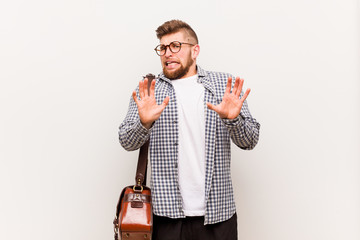 Young modern business man rejecting someone showing a gesture of disgust.