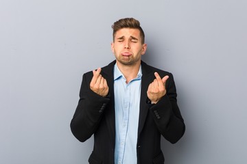 Young handsome caucasian man showing that she has no money.