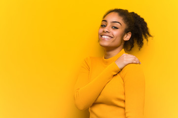 Young black woman closeup over an orange wall