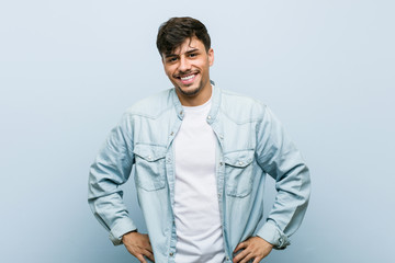 Young hispanic cool man confident keeping hands on hips.