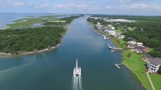 Large White Catamaran Enters Taylors Creek Beaufort, North Carolina. Luxurious Aerial Drone Shot