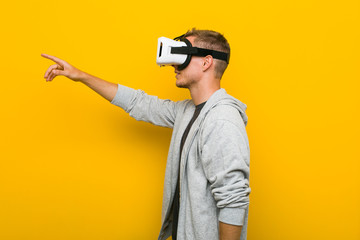 Young caucasian man using a virtual reality glasses